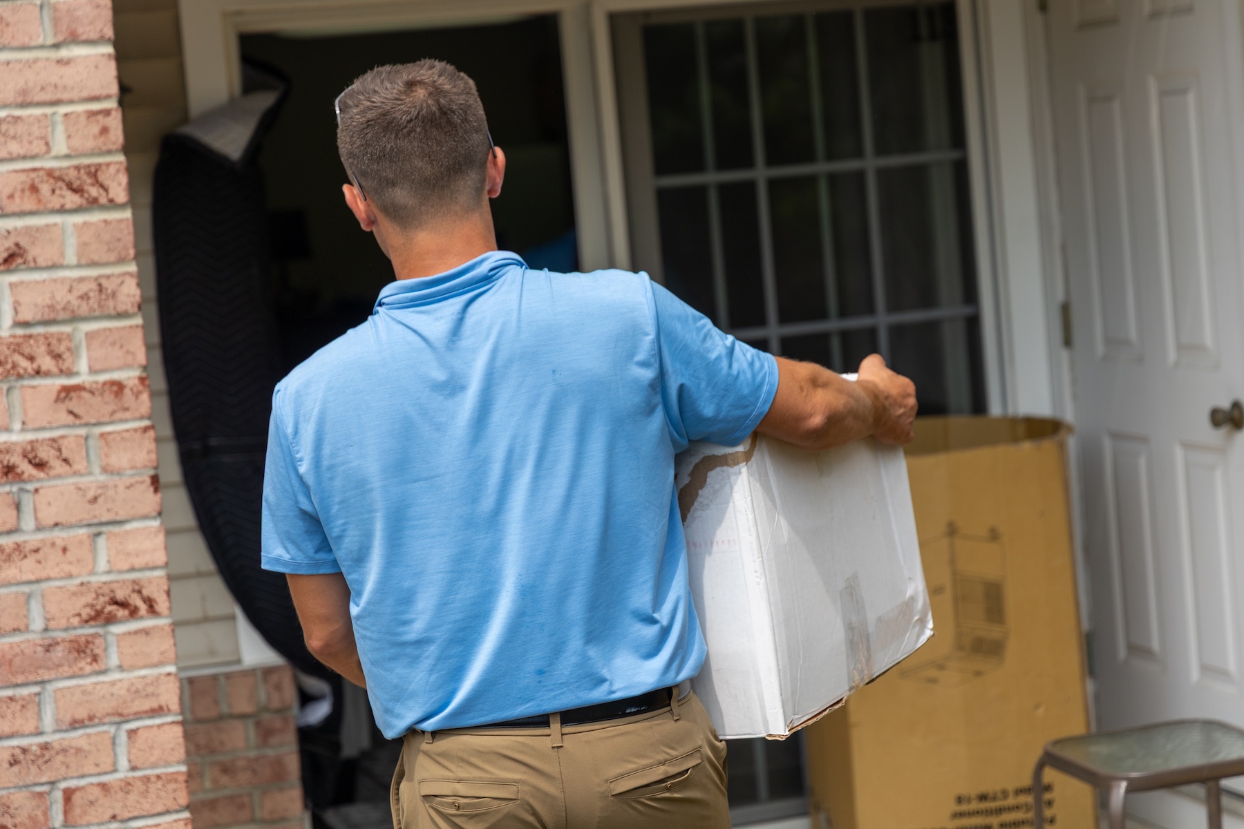 a man standing in front of a brick building