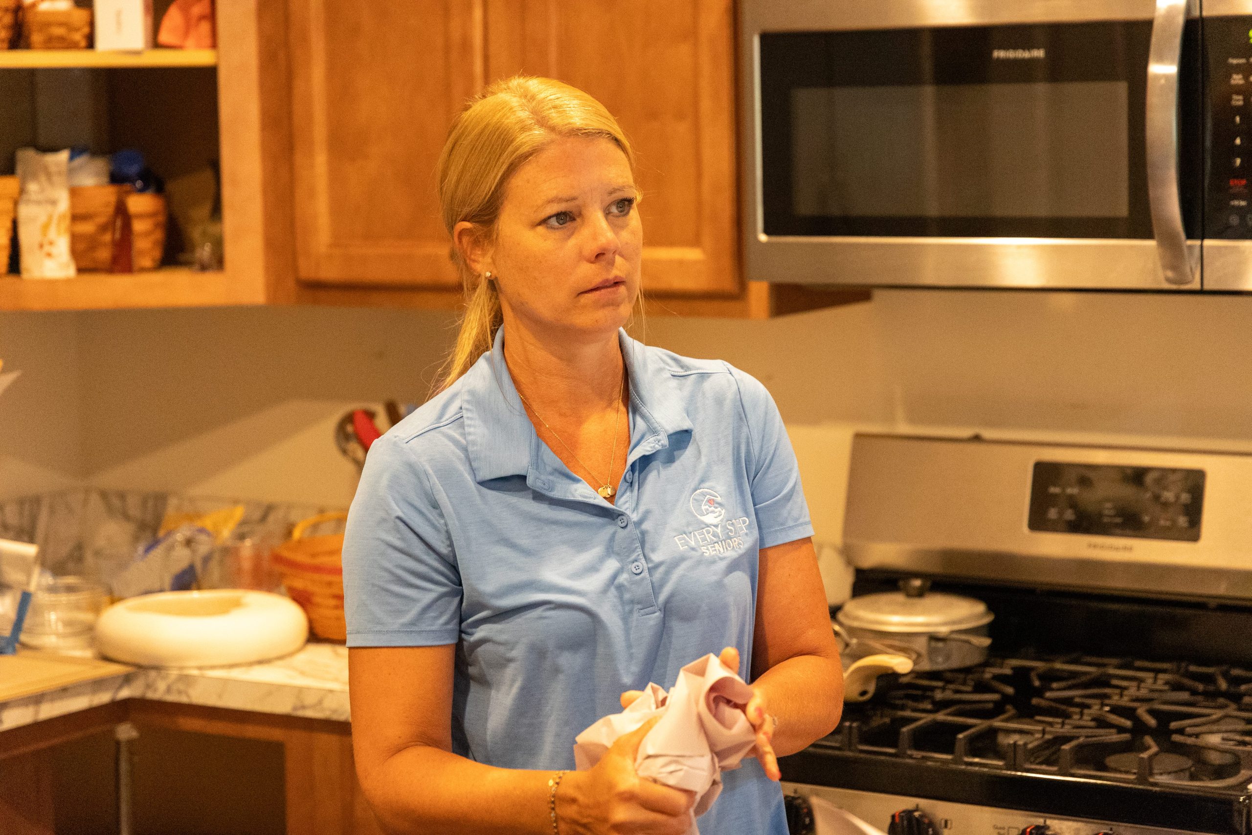 a person standing next to a stove top oven
