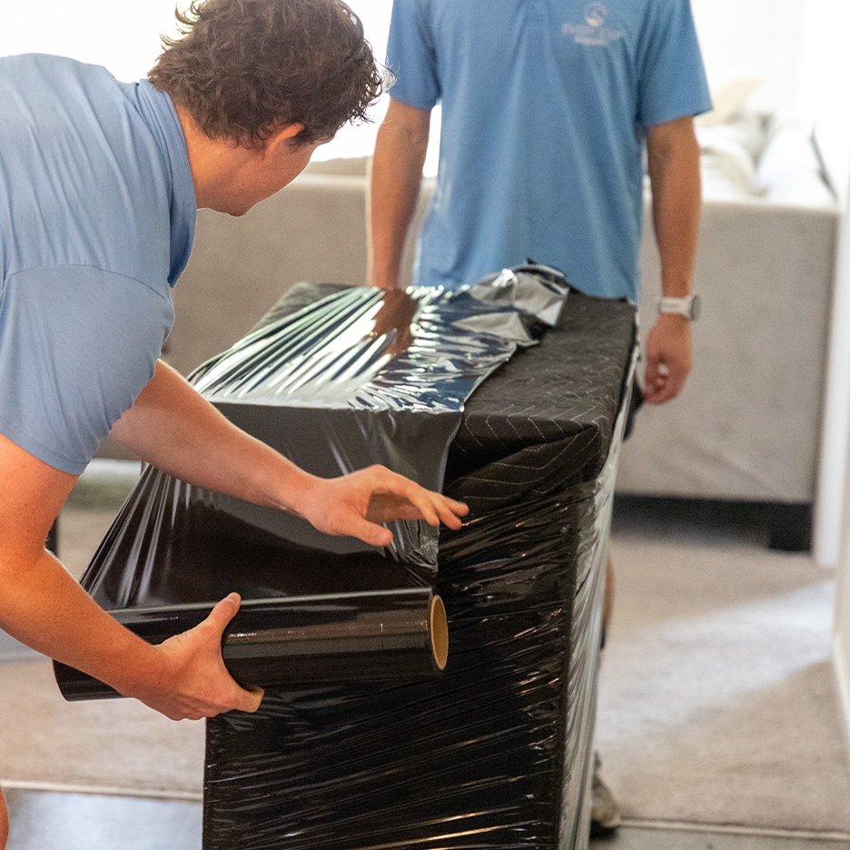 a man standing next to a laptop
